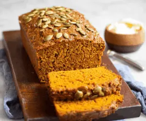 Delicious homemade vegan pumpkin bread sliced and ready to serve, featuring a moist texture and warm autumn spices