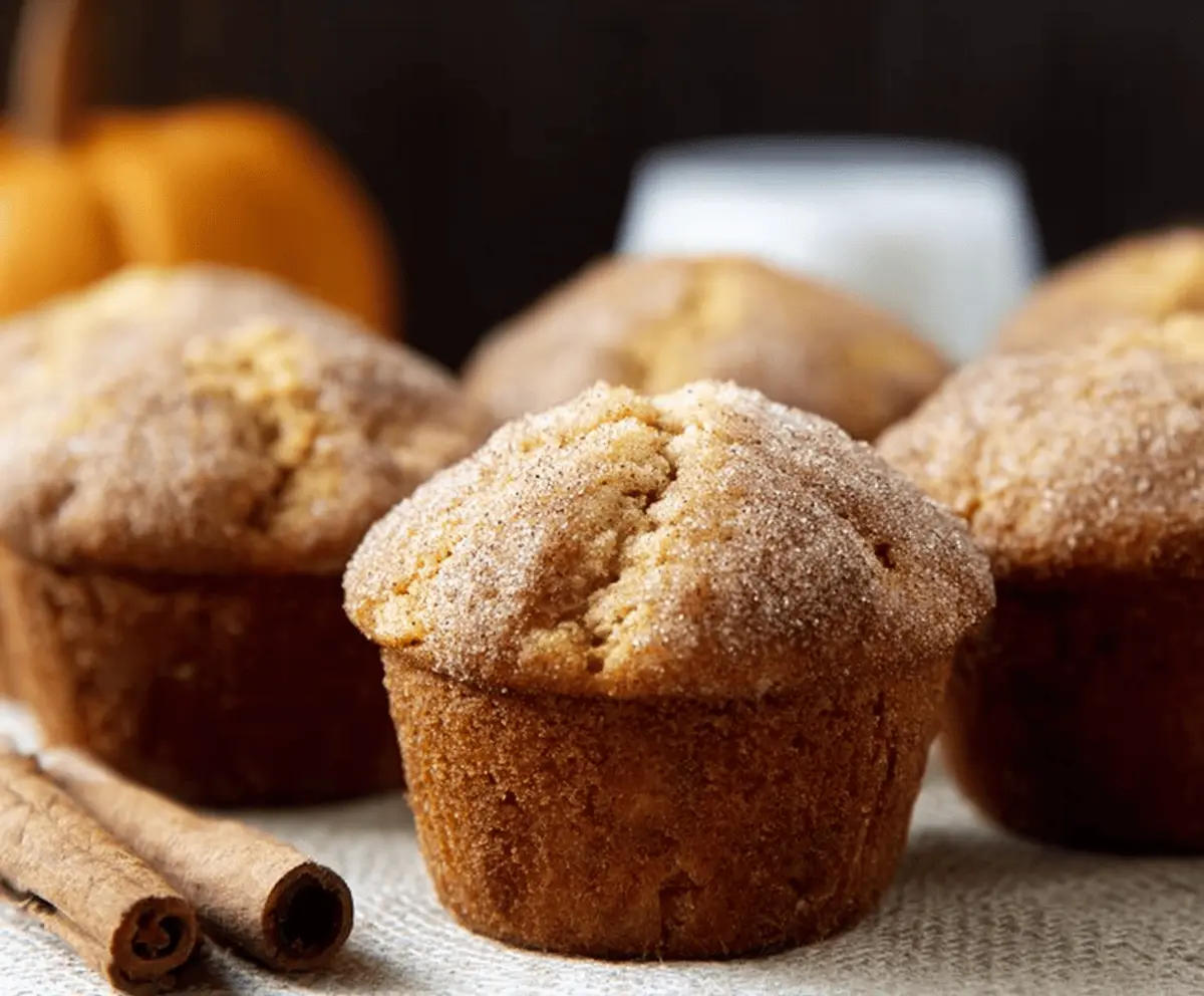 Delicious Pumpkin Snickerdoodle Muffins topped with cinnamon sugar, featuring moist pumpkin flavor and soft, fluffy texture, perfect for fall desserts.