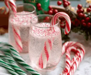 Refreshing Candy Cane Spritzer cocktail in a festive glass with a candy cane garnish for holiday celebration