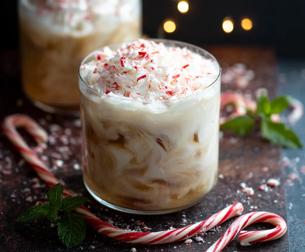Refreshing Peppermint White Russian cocktail garnished with mint and whipped cream.