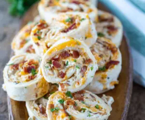 Delicious Bacon Cheddar Ranch Pinwheels on a serving platter, perfect for appetizer snacks.