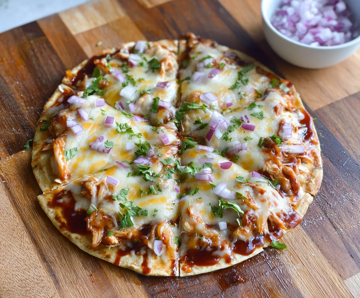 Delicious BBQ Chicken Tortilla Pizza topped with melted cheese and fresh ingredients