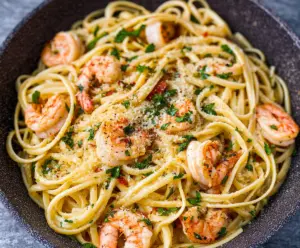 Delicious linguine shrimp scampi on a white plate garnished with parsley.