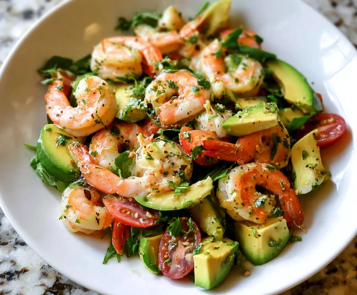 Fresh shrimp and creamy avocado salad served with colorful greens, perfect for a healthy meal.
