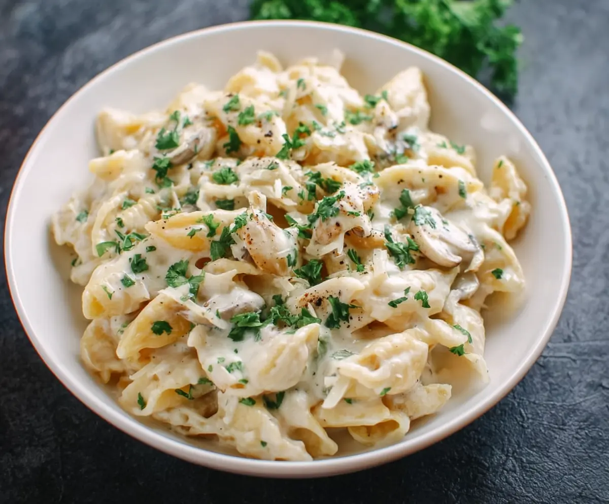 Creamy white pasta sauce served over cooked pasta, perfect for a delicious Italian meal