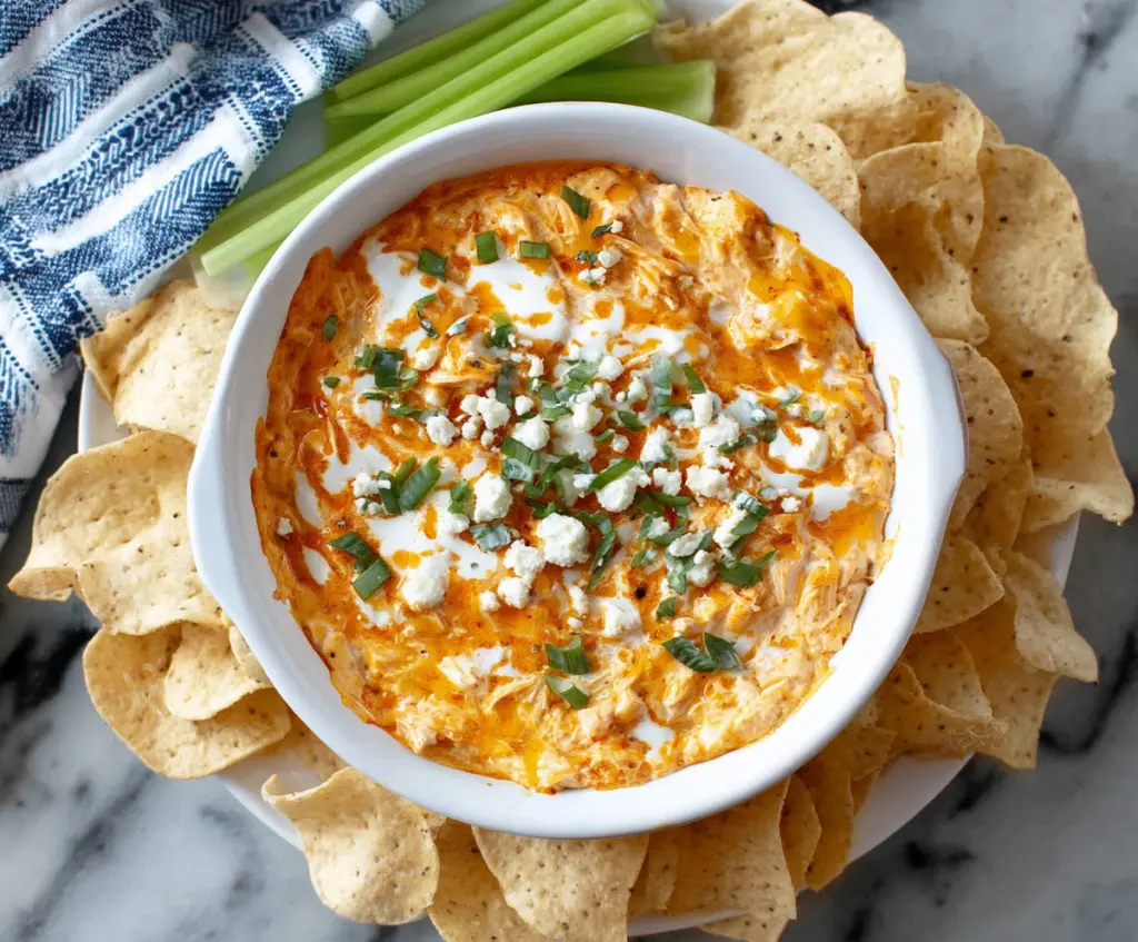 Creamy Greek Yogurt Buffalo Chicken Dip served in a bowl with celery sticks