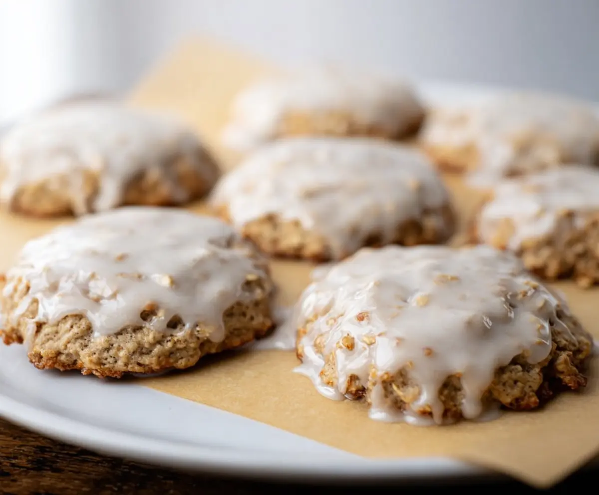 Delicious sourdough discard glazed oatmeal cookies on a wooden platter, showcasing a golden-brown crust and glazed topping.