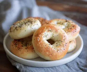 Homemade 2 Ingredient Bagels on a wooden cutting board, ready to serve