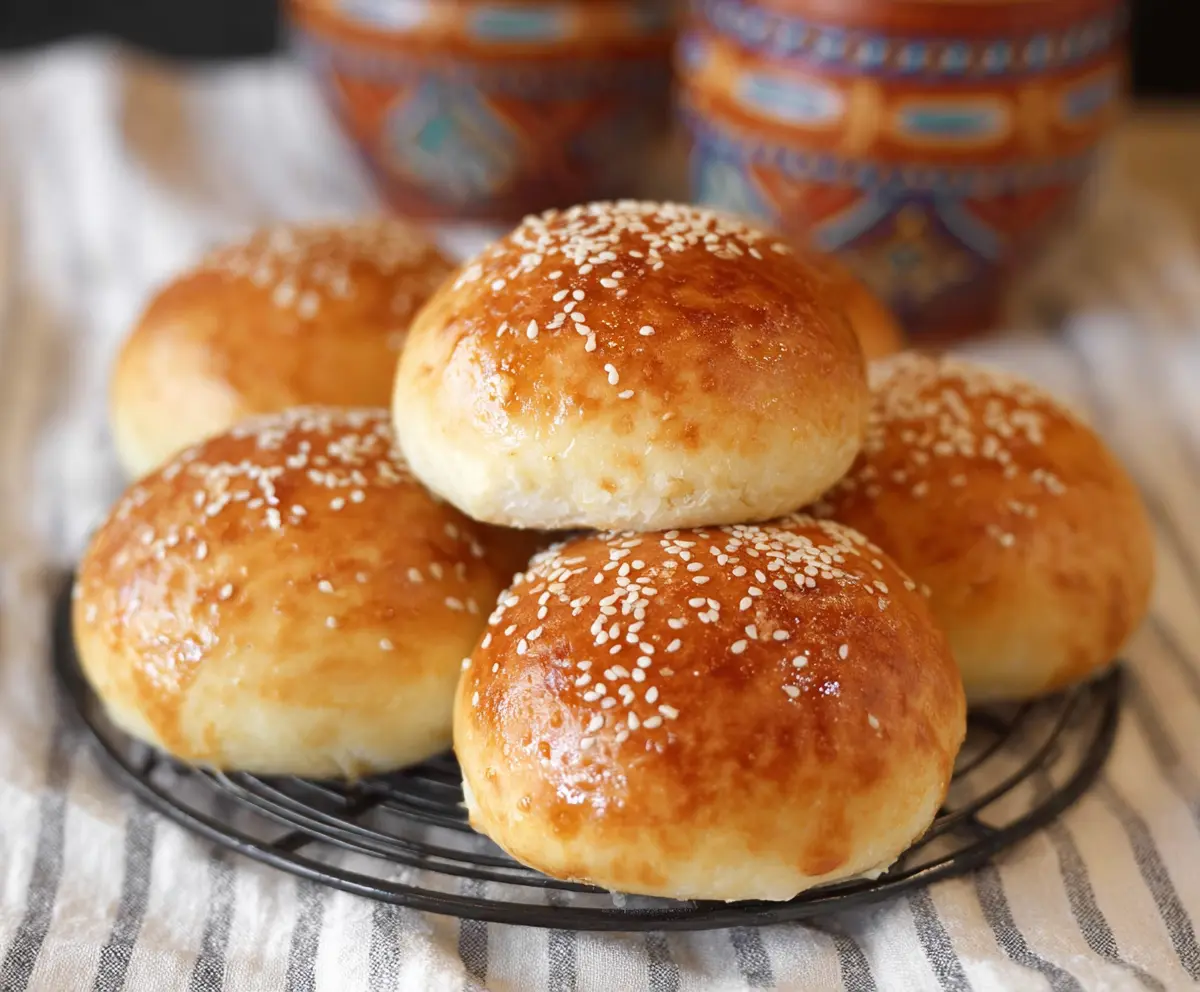 Delicious homemade cottage cheese buns on a rustic wooden table, perfect for breakfast or snacks.