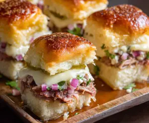 Delicious Cuban Sliders with juicy roast pork, ham, Swiss cheese, and pickles on soft slider buns.