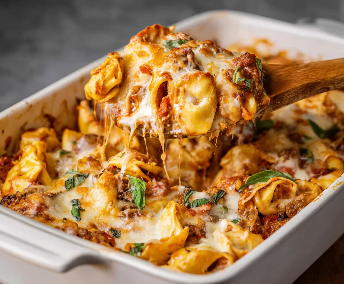 Delicious Million Dollar Tortellini Casserole with melted cheese and fresh basil garnish