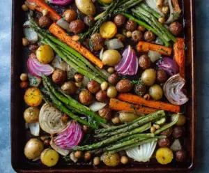 Colorful sheet pan spring vegetables with asparagus, cherry tomatoes, and bell peppers, recipe ready to serve.