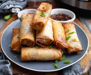 Crispy Air Fryer Spring Rolls filled with fresh vegetables and served with dipping sauce
