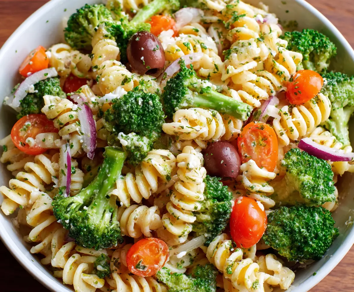 Colorful broccoli pasta salad with fresh vegetables and herbs, perfect for a healthy meal.