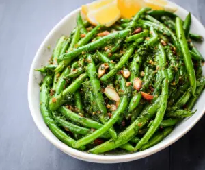 Delicious Dijon Green Beans garnished with herbs, perfect as a healthy side dish.