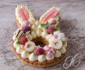 Delicious Easter Bunny Cream Tart with colorful decorations on a festive table.