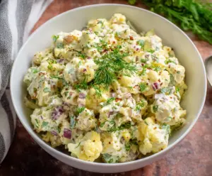 Delicious keto cauliflower potato salad with fresh ingredients and creamy dressing