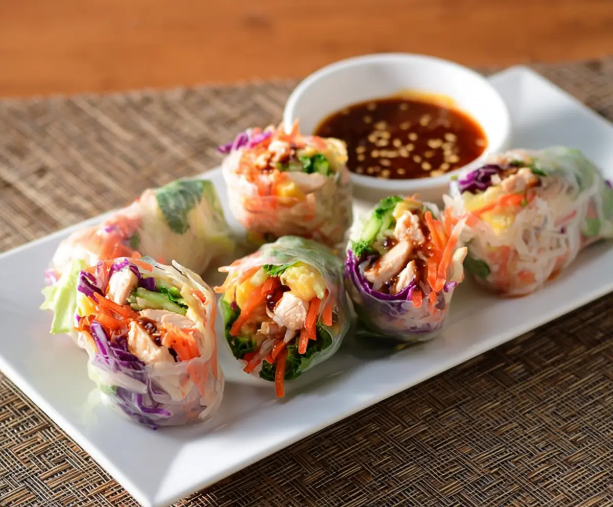 Delicious Teriyaki Chicken Rice Paper Rolls filled with fresh vegetables and savory chicken.